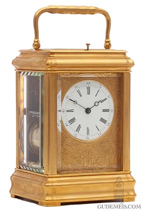 A French gilt brass gorge case carriage clock with engraved mask, circa 1870. 