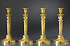A superb set of four Empire gilt bronze candlesticks attributed to Claude Galle 