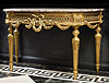 A very fine Louis XVI carved giltwood demi-lune grande console, the shaped and moulded demi-lune brêche rose marble top