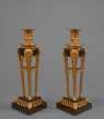 Rare Pair of Gilt and Patinated Bronze Candlesticks 
Probably Italian, Empire period, circa 1810-1815
Height 28 cm; width of each side of the base 12.7 cm 
 