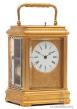 A French gilt brass gorge case carriage clock with engraved mask, circa 1870.