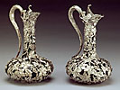 A beautiful pair of sterling silver claret jugs
