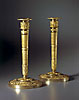 A very elegant pair of Empire gilt bronze candlesticks