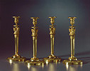 A superb set of four Empire gilt btonze candlesticks