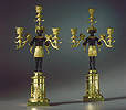 An extremely rare pair of patinated and gilt bronze Candelabra