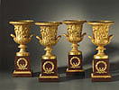 An exceedingly fine set of four Empire gilt bronze Medici vases