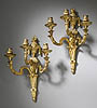 A superb pair of Louis XVI gilt bronze three-light wall-lights in the style of Jean-Charles Delafosse