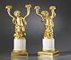 A fine pair of early nineteenth century gilt bronze and white marble figural two-light candelabra