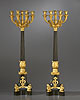 A large and imposing pair of Empire gilt and patinated bronze nine-light candelabra attributed to Pierre-Philippe Thomire